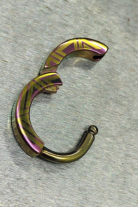 one of our most popular septum or helix clicker, with some of the newest patterns, pink and yellow anodized on medical grade titanium